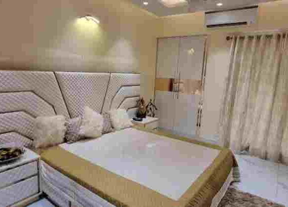 a bed with pillows in a room
